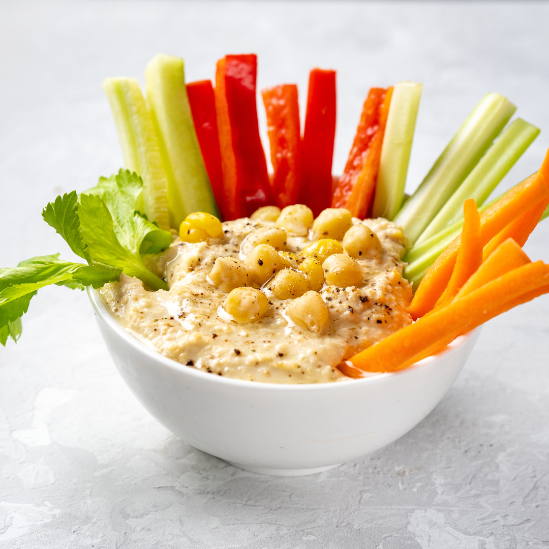 Hummus, made from chickpeas, is rich in protein and fiber, making it an ideal PCOS snack for managing hunger and stabilizing blood sugar levels. 